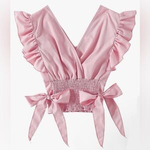 Light pink, low V-neck blouse with bows on the side and ruffles at sleeves.